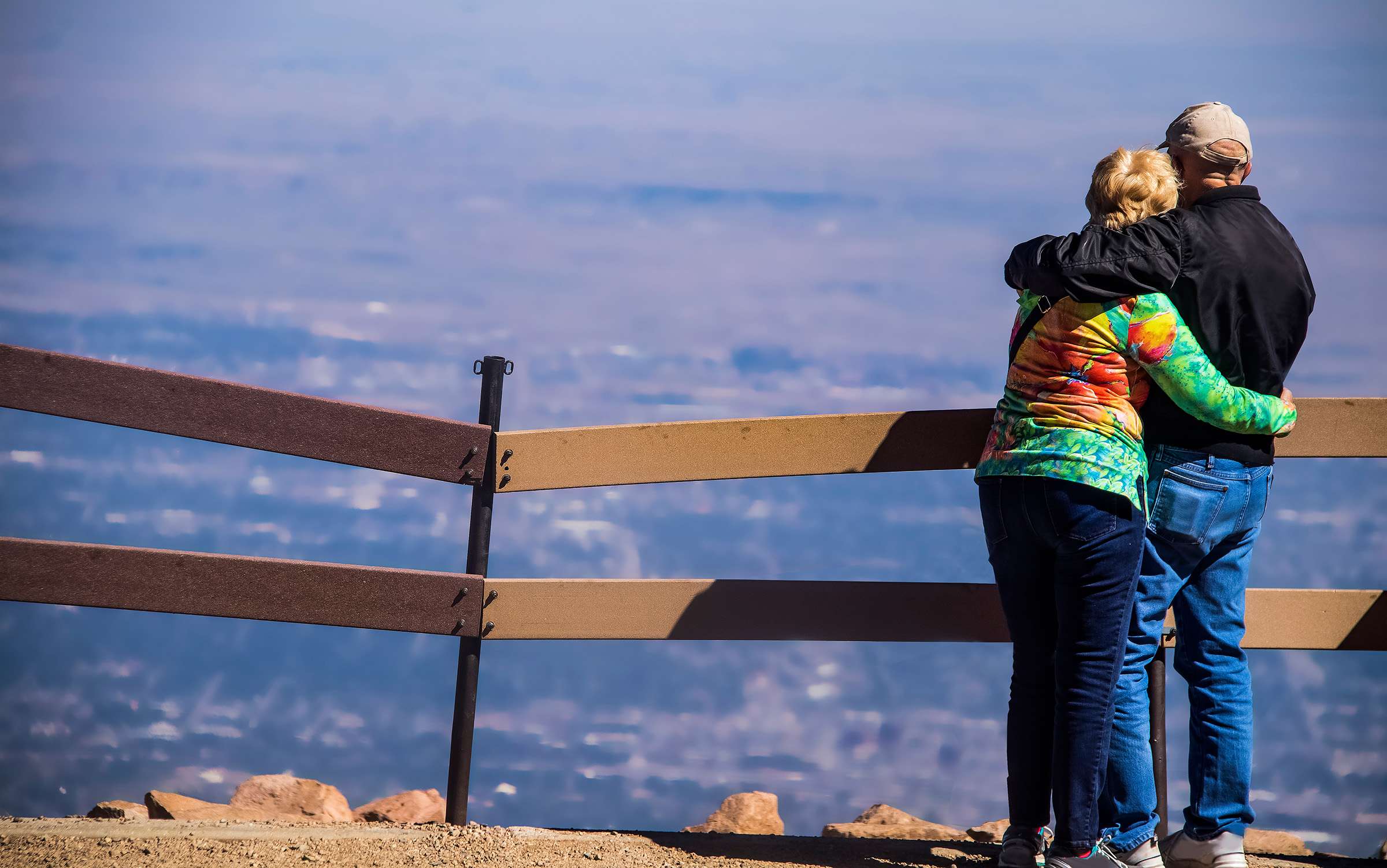 A couple overlooks the valley from Pikes Peak, Colorado.