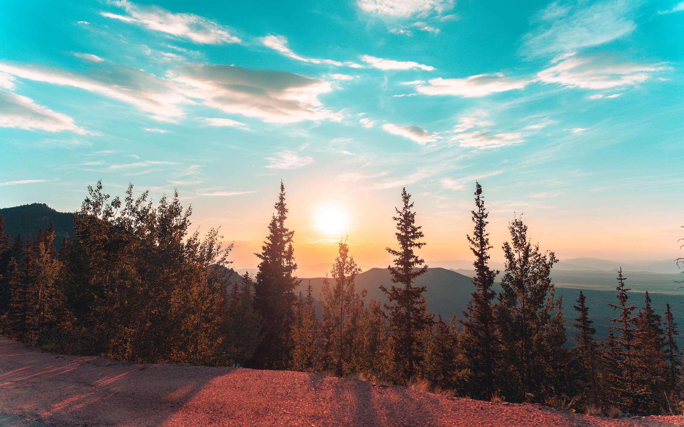 A Mountain View with evergreen trees and the sunset