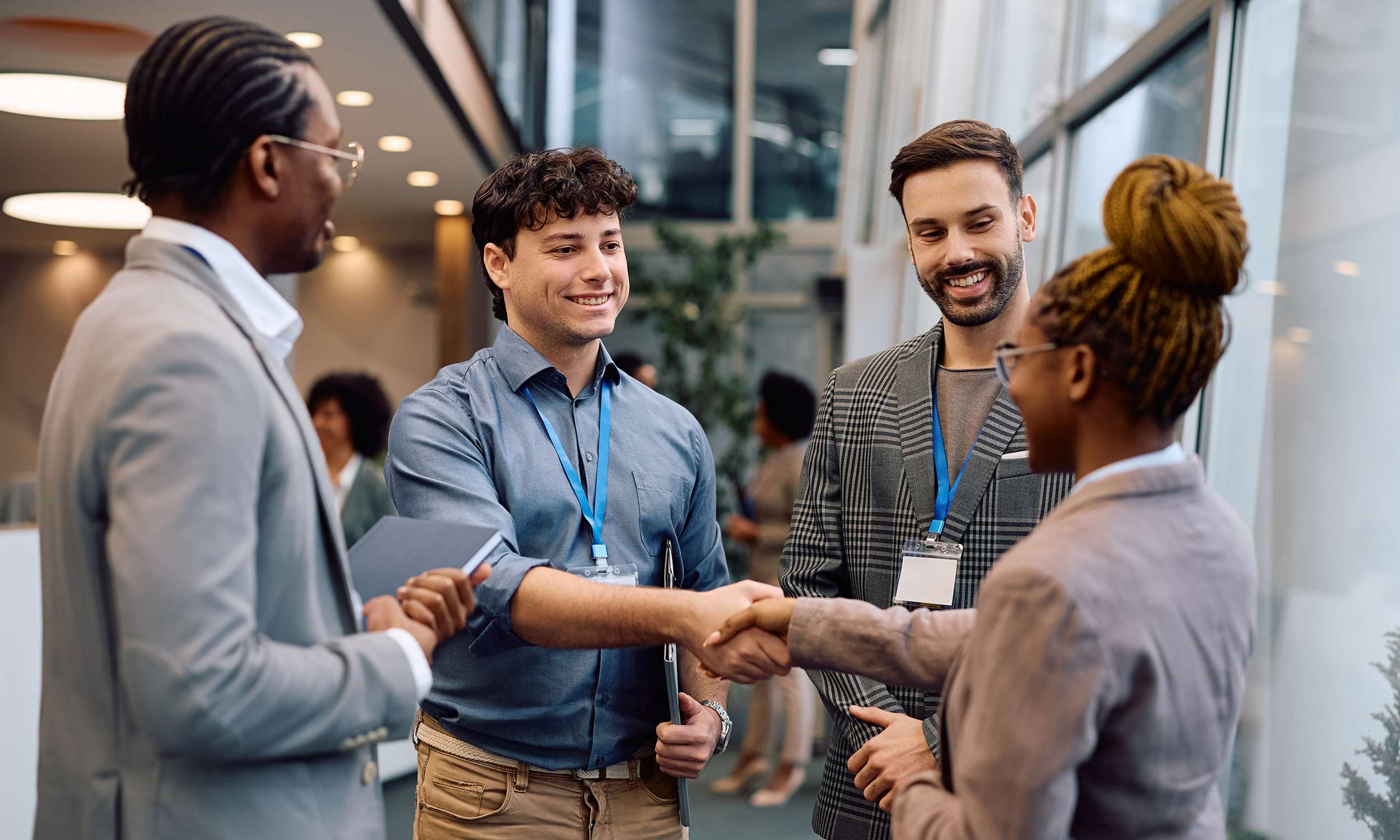 Business people shaking hands and networking at an event or conference.