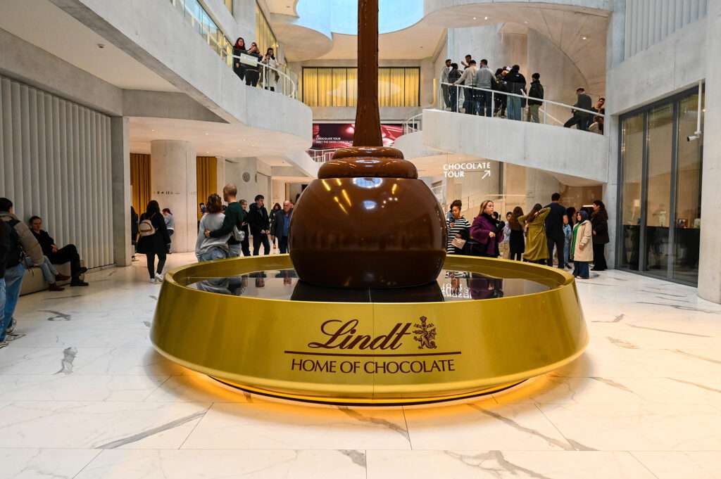Giant Chocolate fountain labeled "Lindt, Home of Chocolate"